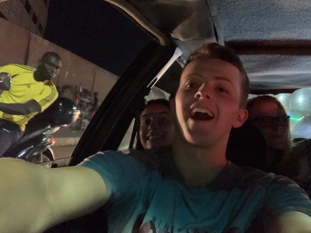 Quincy, Leah, and myself taxiing to my first (and only) football match w/ friend + program assistant Pape riding alongside.